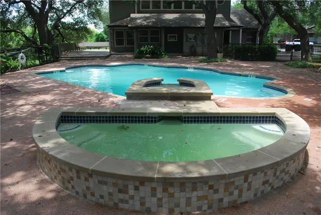 a view of a swimming pool with a backyard
