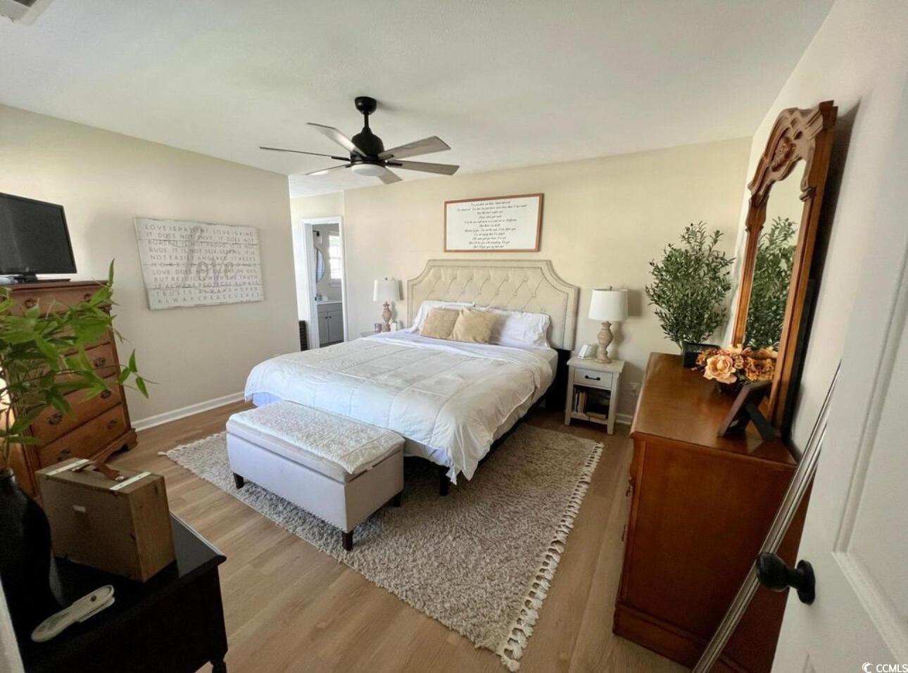 232 Oak Lea Drive Conway, SC 29526 - Photo 8 of 16 Bedroom featuring wood finished floors, a ceiling fan, and ensuite bath