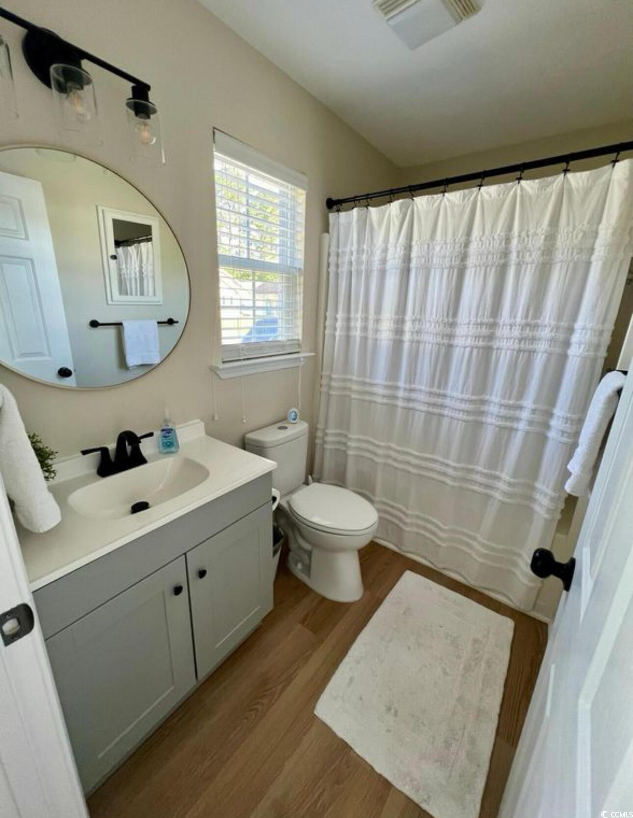 232 Oak Lea Drive Conway, SC 29526 - Photo 10 of 16 Bathroom featuring light wood-style flooring, vanity, and curtained shower
