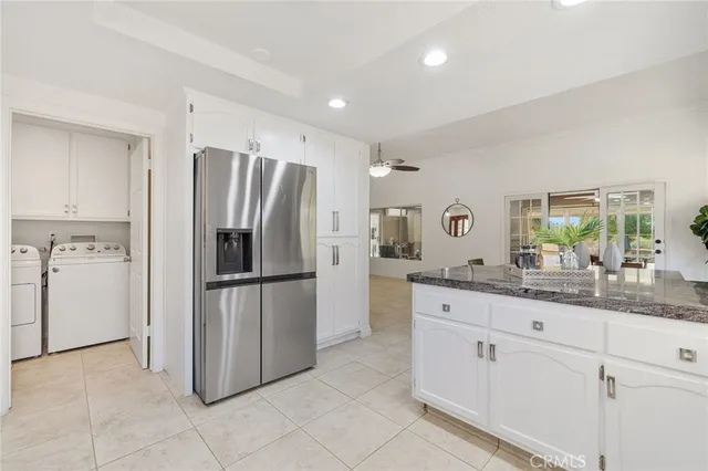a kitchen with stainless steel appliances a refrigerator sink and cabinets
