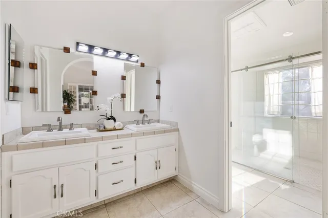 a bathroom with a double vanity sink mirror and