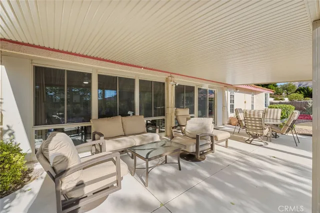 a building outdoor space with patio furniture and potted plants