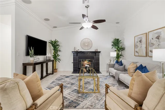 a living room with furniture a fireplace and a flat screen tv