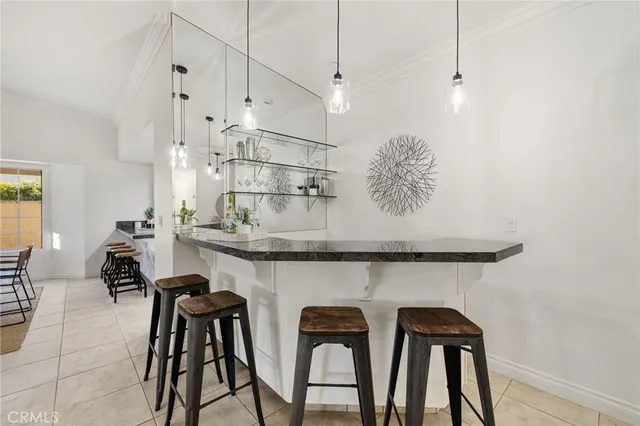 a kitchen with stainless steel appliances granite countertop a sink and a refrigerator