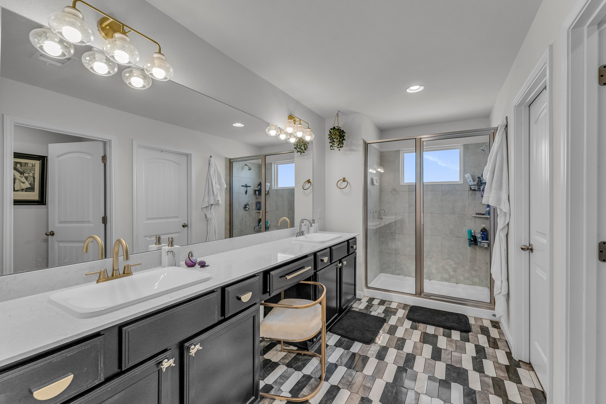 306 Cold Spg Loop Bastrop, TX 78602 - Photo 15 of 25 Bathroom with double vanity, a stall shower, and a sink