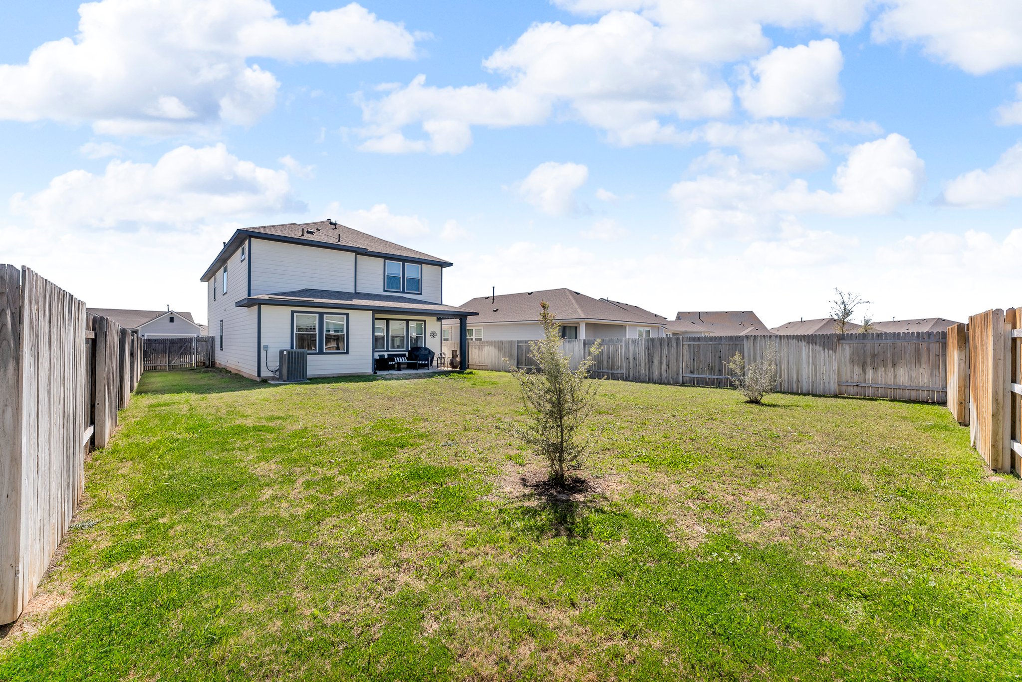 306 Cold Spg Loop Bastrop, TX 78602 - Photo 25 of 25 View of yard featuring central AC unit and a fenced backyard