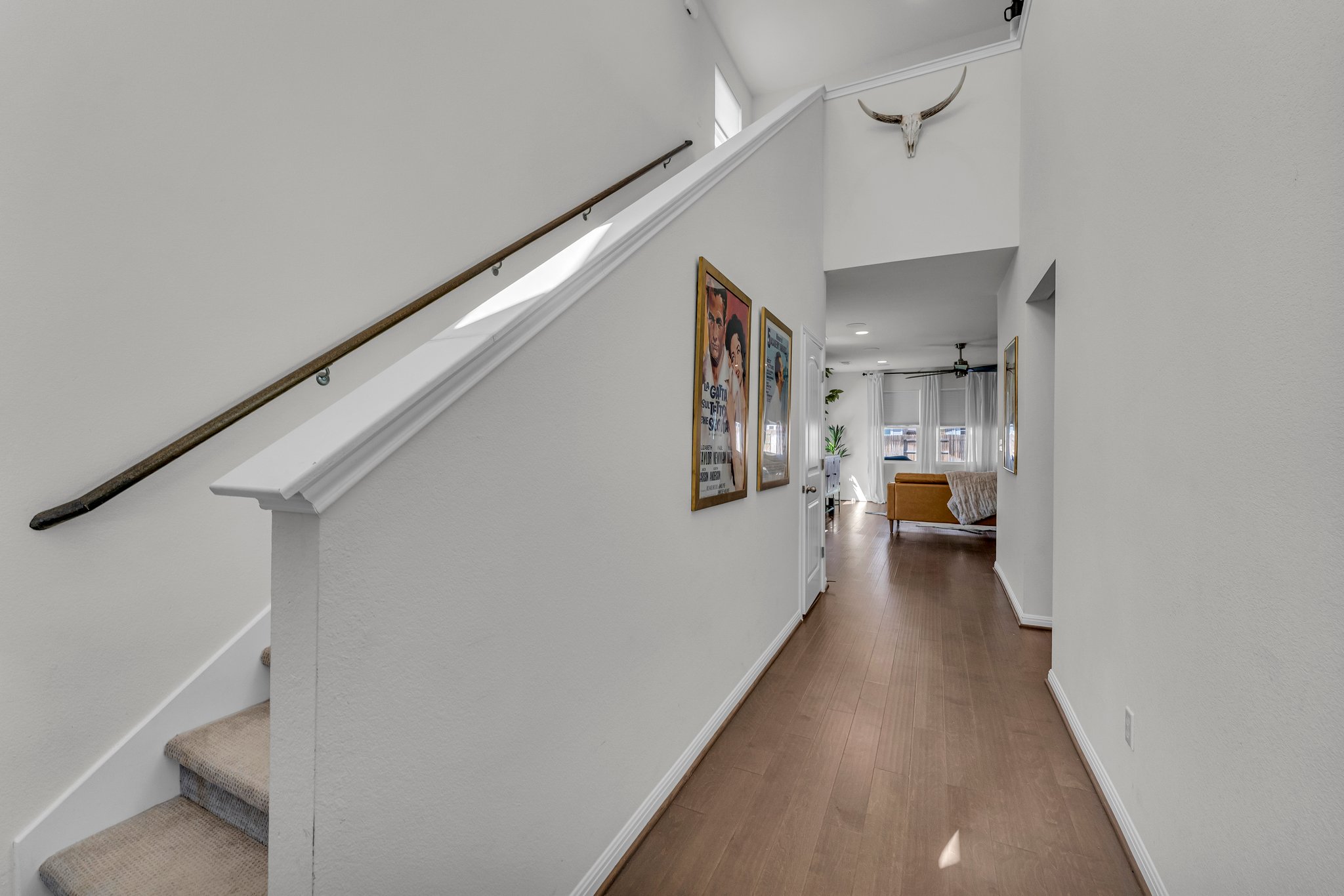 306 Cold Spg Loop Bastrop, TX 78602 - Photo 4 of 25 Corridor with stairway, a towering ceiling, baseboards, and wood finished floors