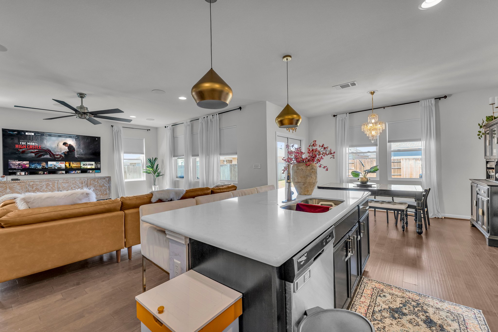 306 Cold Spg Loop Bastrop, TX 78602 - Photo 9 of 25 Kitchen featuring a healthy amount of sunlight, wood finished floors, visible vents, a sink, and dishwasher