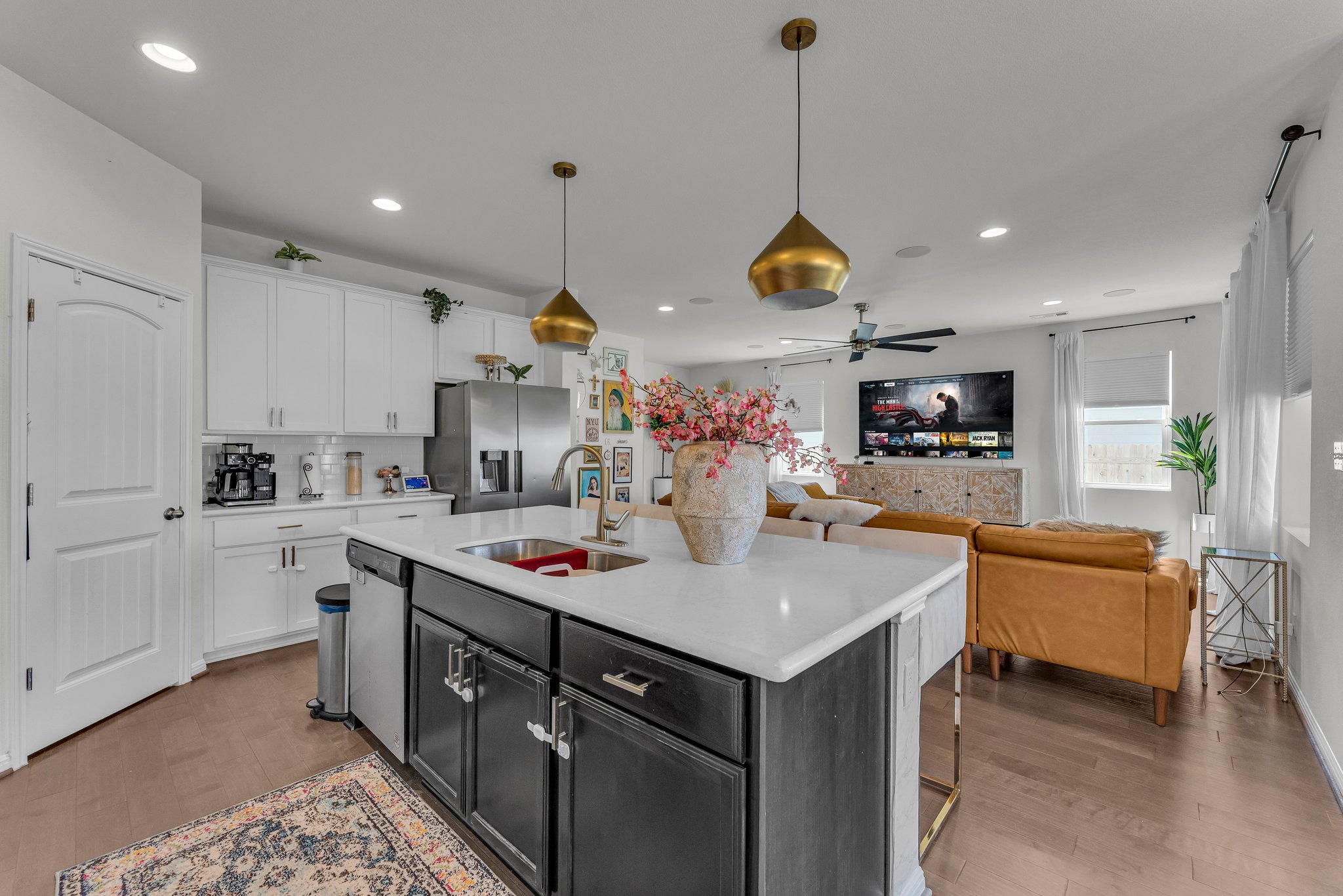 306 Cold Spg Loop Bastrop, TX 78602 - Photo 10 of 25 Kitchen with appliances with stainless steel finishes, white cabinetry, light countertops, and a sink