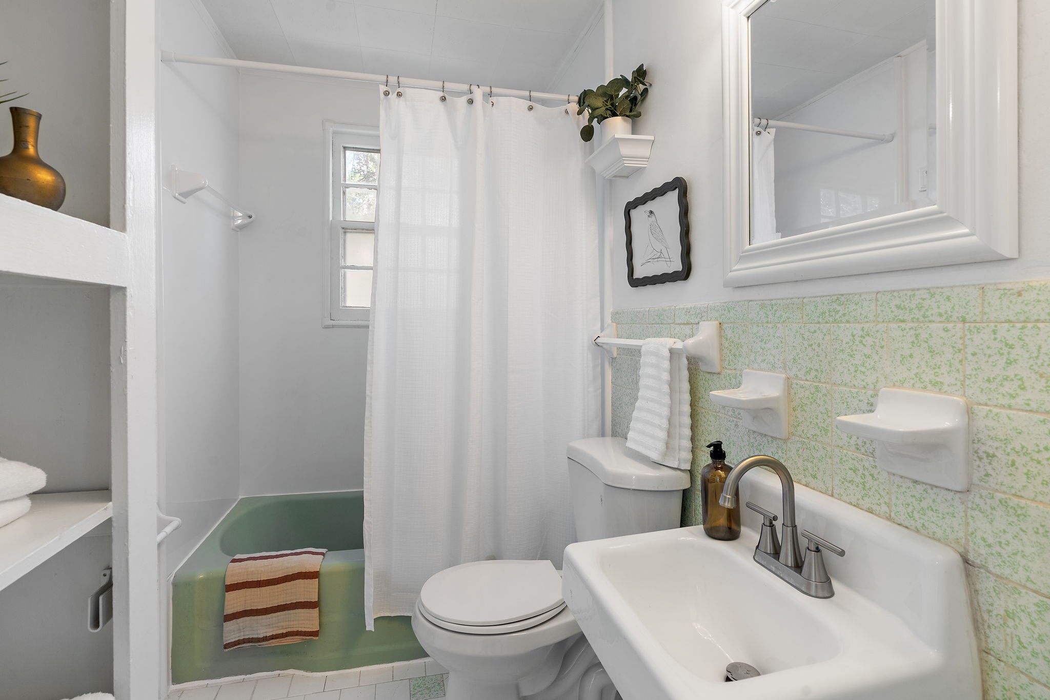 236 Barker Road Nashville, TN 37214 - Photo 16 of 45 This stylish bathroom has everything you need - ample storage, gorgeous mid-century green tiles, a tub/shower combo, brand new faucet, and a mid-century floating sink to boot.