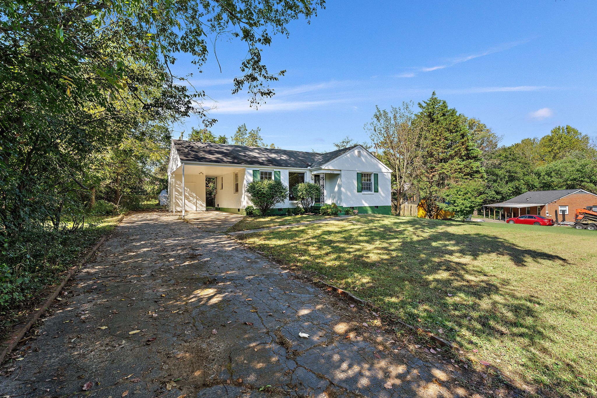 236 Barker Road Nashville, TN 37214 - Photo 2 of 45 The driveway is wide, and ends at the attached 1 car carport, with ample off street parking.