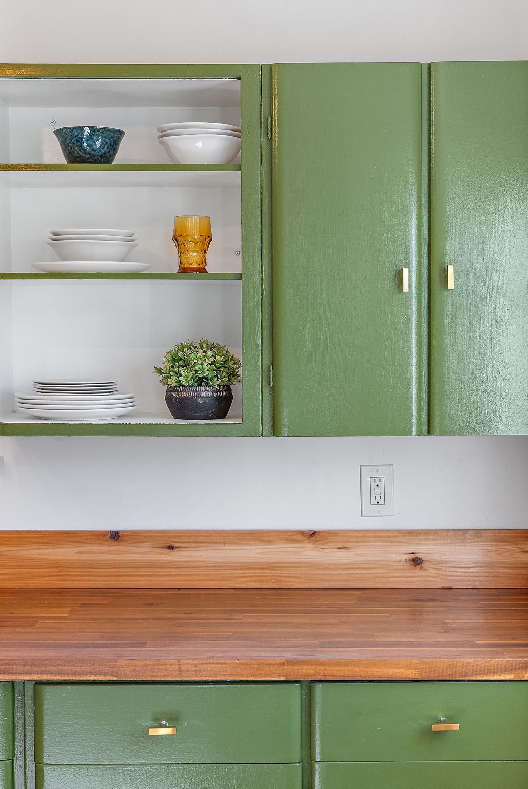 236 Barker Road Nashville, TN 37214 - Photo 26 of 45 The attention to the detail in the kitchen is stunning - beautiful exposed shelving, an inviting olive on the cabinets, and modern gold hardware play wonderfully with brand new butcher block countertops.