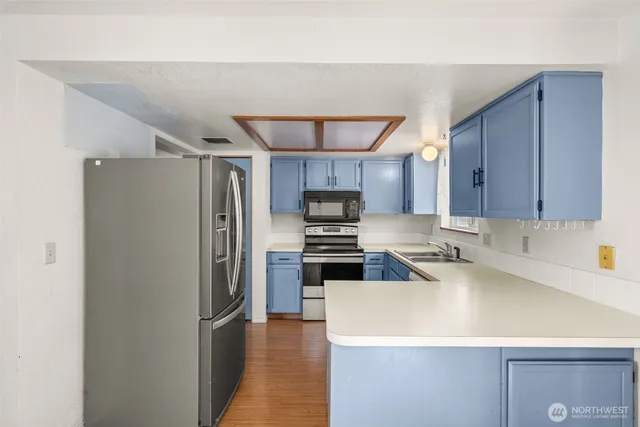 a kitchen with a sink stove and microwave