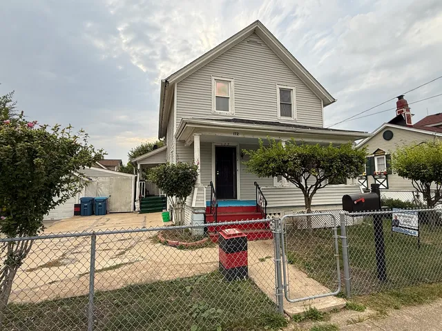 a patio with sofas fire pit table and chairs