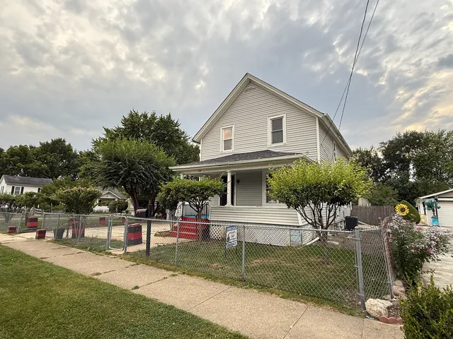 a view of house with outdoor space and garden