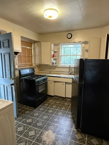 a kitchen with a sink stove and refrigerator