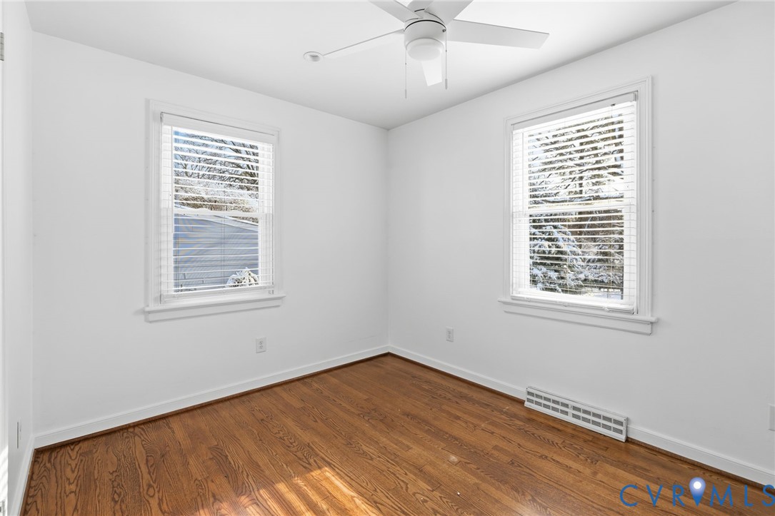 7117 Brigham Road Richmond, VA 23226 - Photo 14 of 20 a view of an empty room with a window and wooden floor