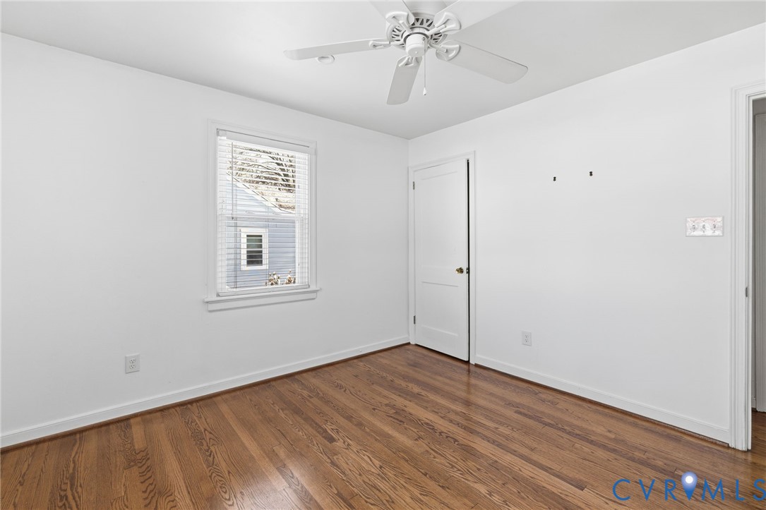 7117 Brigham Road Richmond, VA 23226 - Photo 16 of 20 a view of an empty room with wooden floor and a window