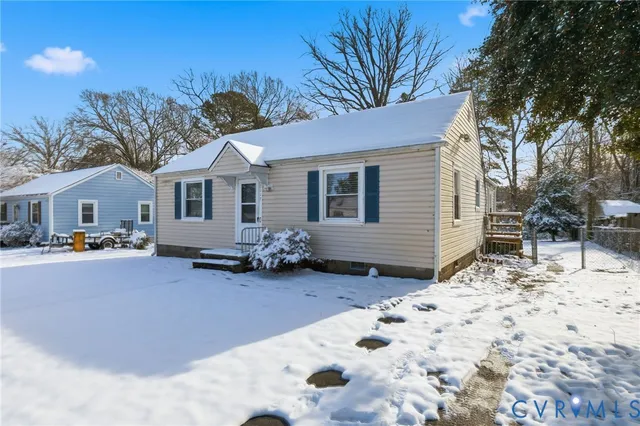 a view of a house with a yard covered in snow