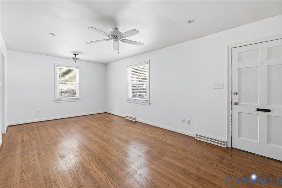 7117 Brigham Road Richmond, VA 23226 - Photo 4 of 20 a view of an empty room with wooden floor and a window