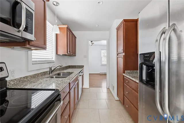 a kitchen with a sink stove and refrigerator
