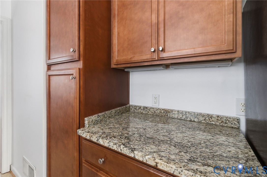 7117 Brigham Road Richmond, VA 23226 - Photo 8 of 20 a view of kitchen cabinets and wooden floor