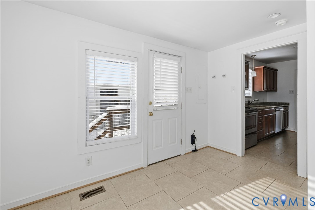 7117 Brigham Road Richmond, VA 23226 - Photo 10 of 20 a view of kitchen and hallway with windows