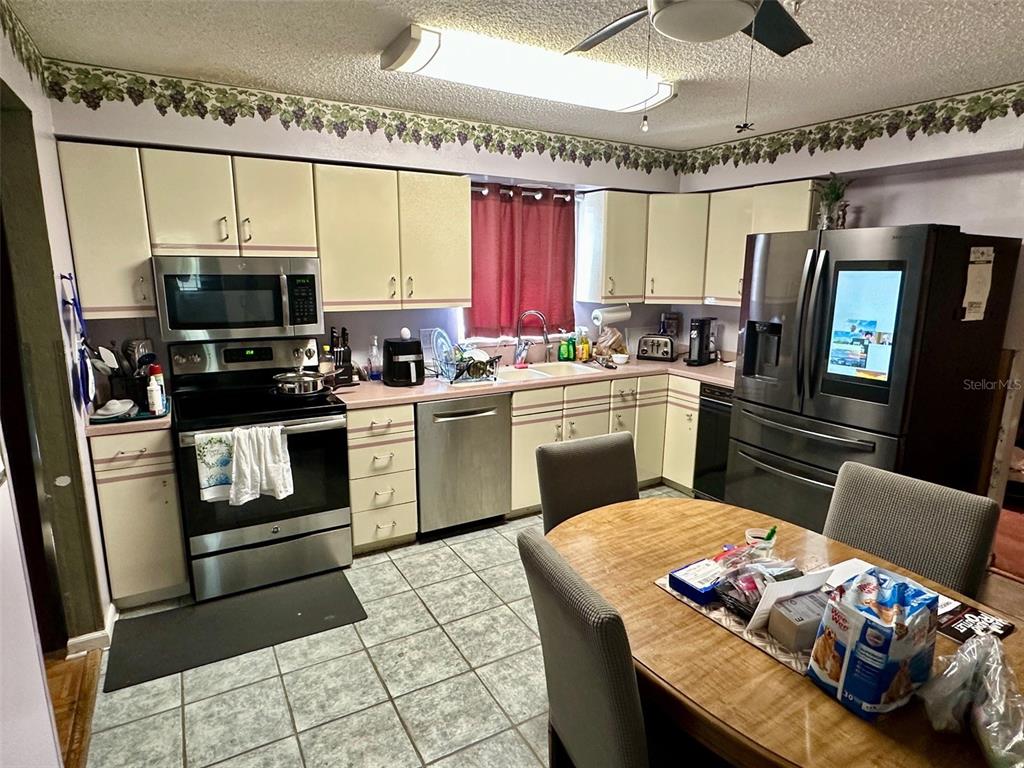 300 Broadview Avenue Altamonte Springs, FL 32701 - Photo 14 of 33 a kitchen with a stove a sink and a refrigerator