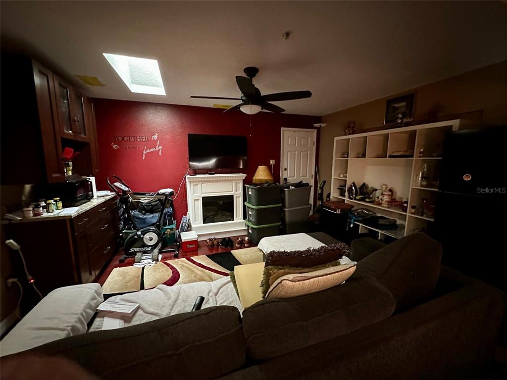 300 Broadview Avenue Altamonte Springs, FL 32701 - Photo 10 of 33 a living room with furniture a lamp and a fireplace