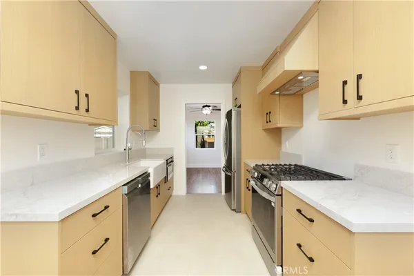 a kitchen with stainless steel appliances a sink and a stove