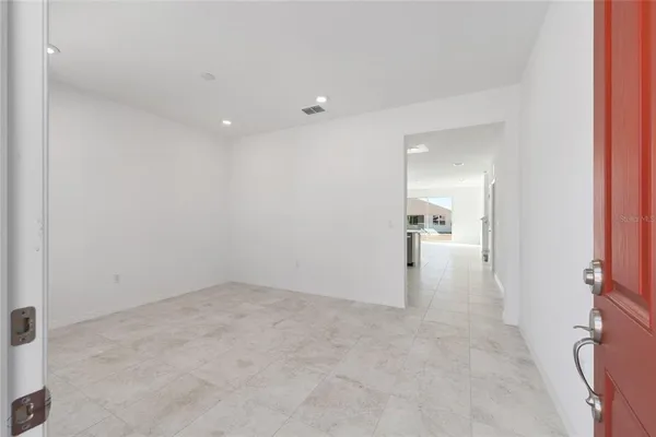 a view of a big room with wooden floor and a bathroom