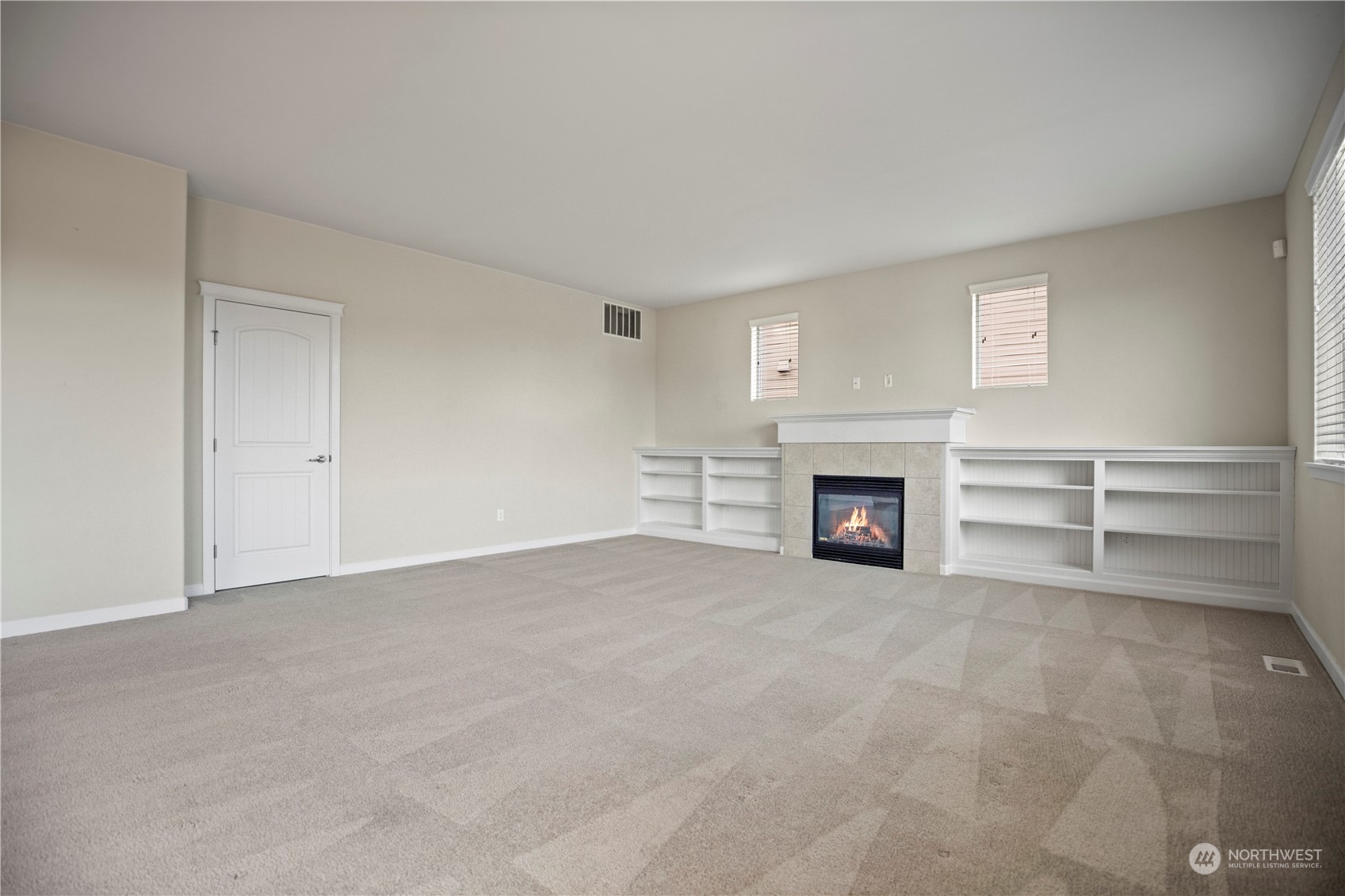 1534 Farina Loop Southeast Olympia, WA 98513 - Photo 15 of 38 a view of an empty room with a fireplace and a window