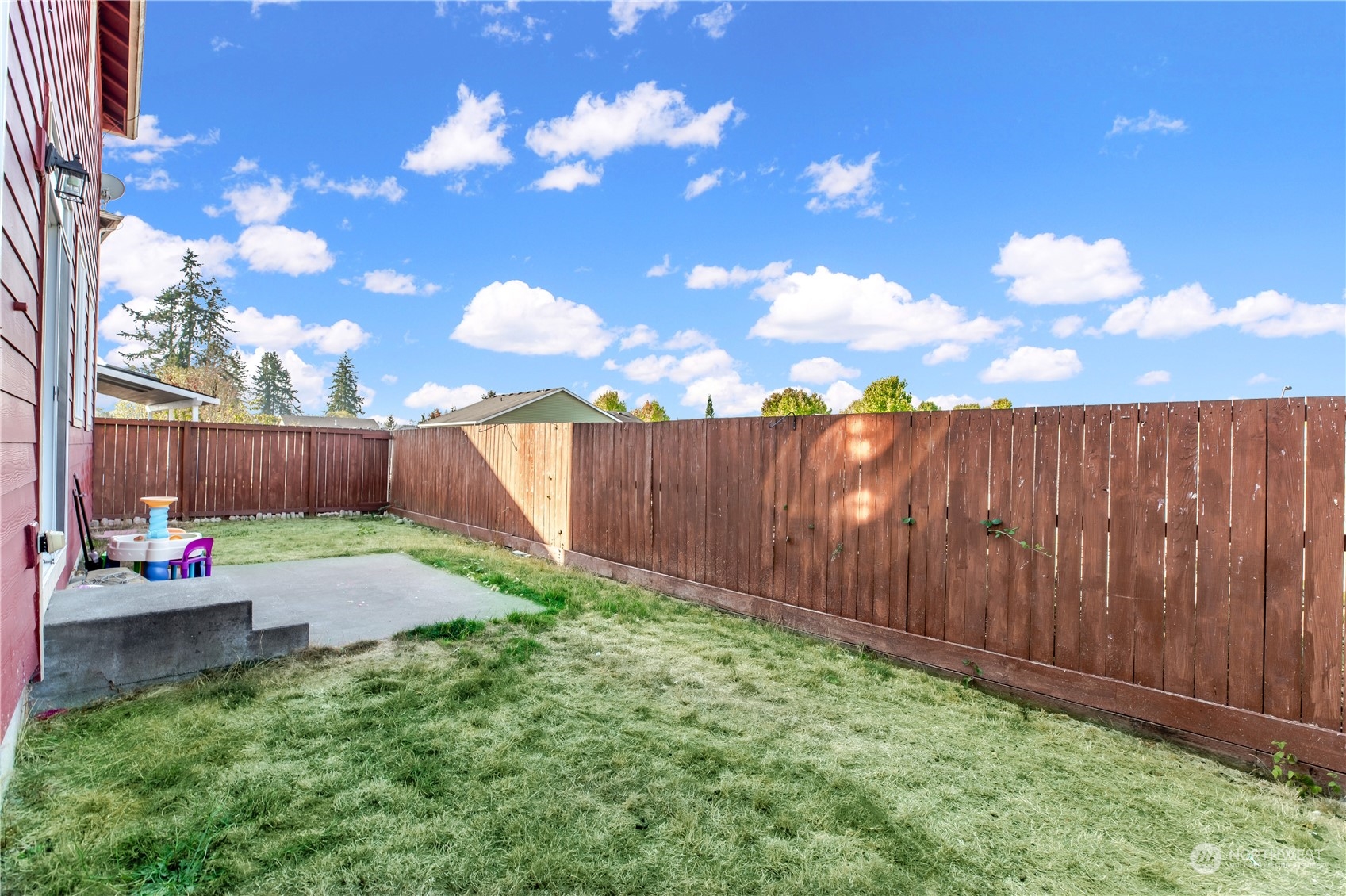 1534 Farina Loop Southeast Olympia, WA 98513 - Photo 33 of 38 a backyard with a table and chairs with wooden fence