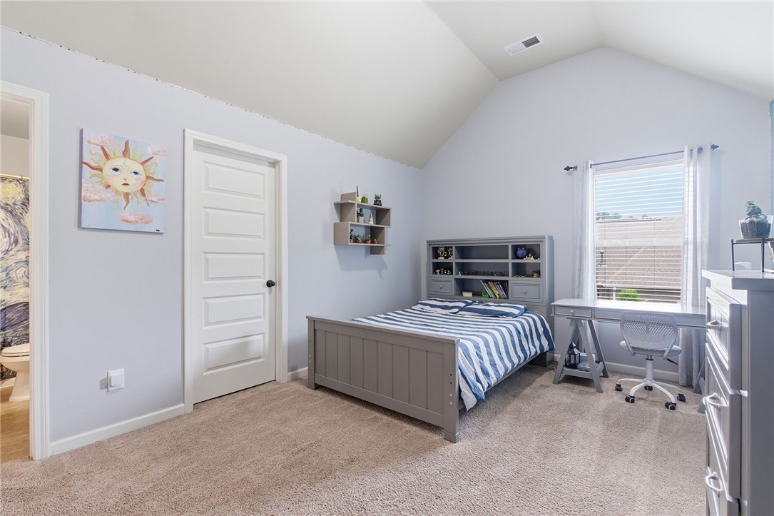 138 Buckland Drive Anderson, SC 29621 - Photo 31 of 49 This cozy bedroom features plush carpeting and a high vaulted ceiling, offering a comfortable and spacious atmosphere.