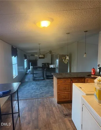 a kitchen with a sink cabinets and wooden floor
