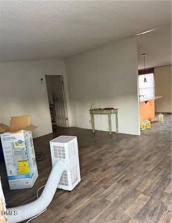 a view of room with wooden floor and gym equipment