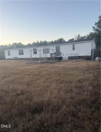 a view of a big house with a yard