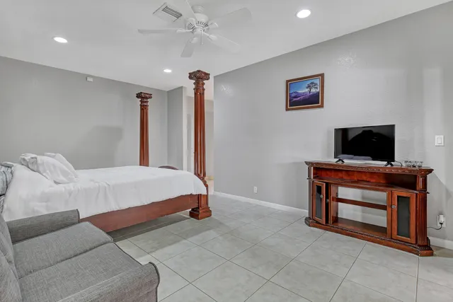 a view of a bedroom with a window and a door