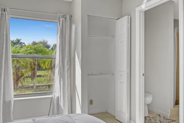 a kitchen with cabinets appliances and a window