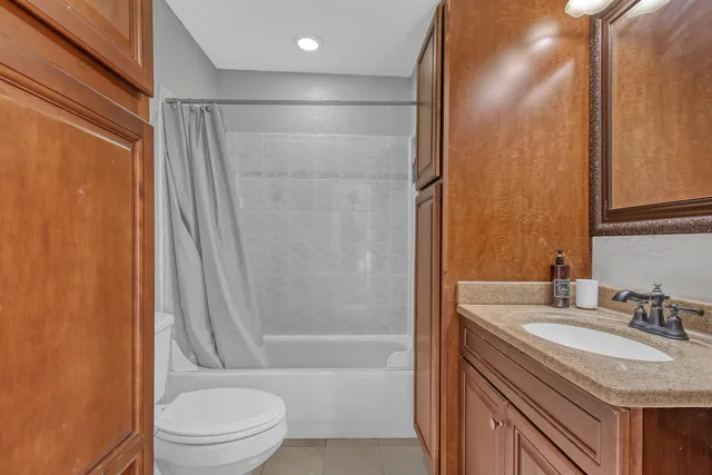 a large bathroom with a large mirror vanity and a sink