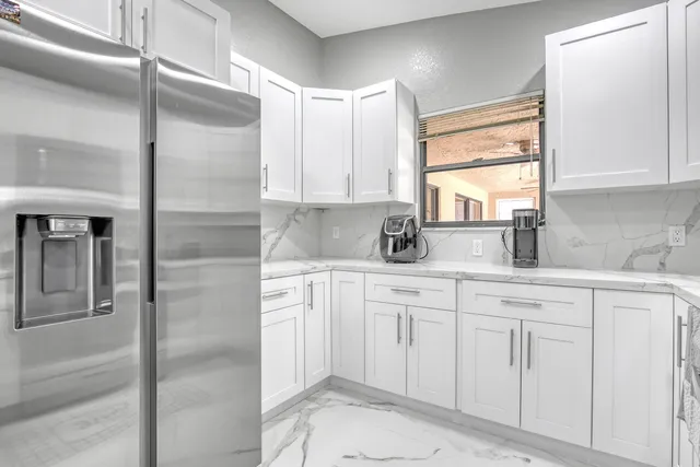 a view of a room with a large window and furniture