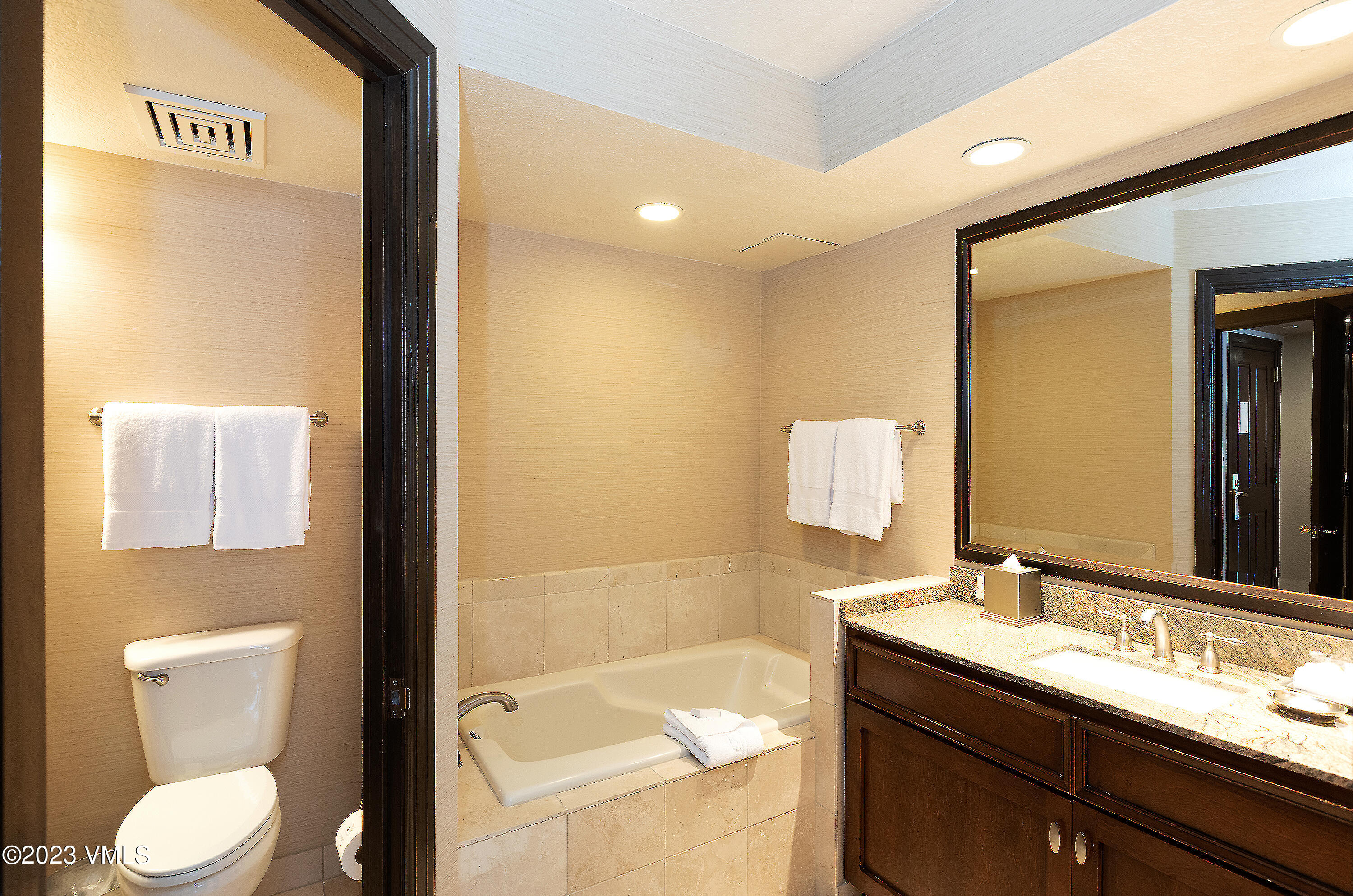 210 Offerson Road, Unit 107 WEEK 5 Beaver Creek, CO 81620 - Photo 16 of 27 a bathroom with a granite countertop sink toilet and mirror