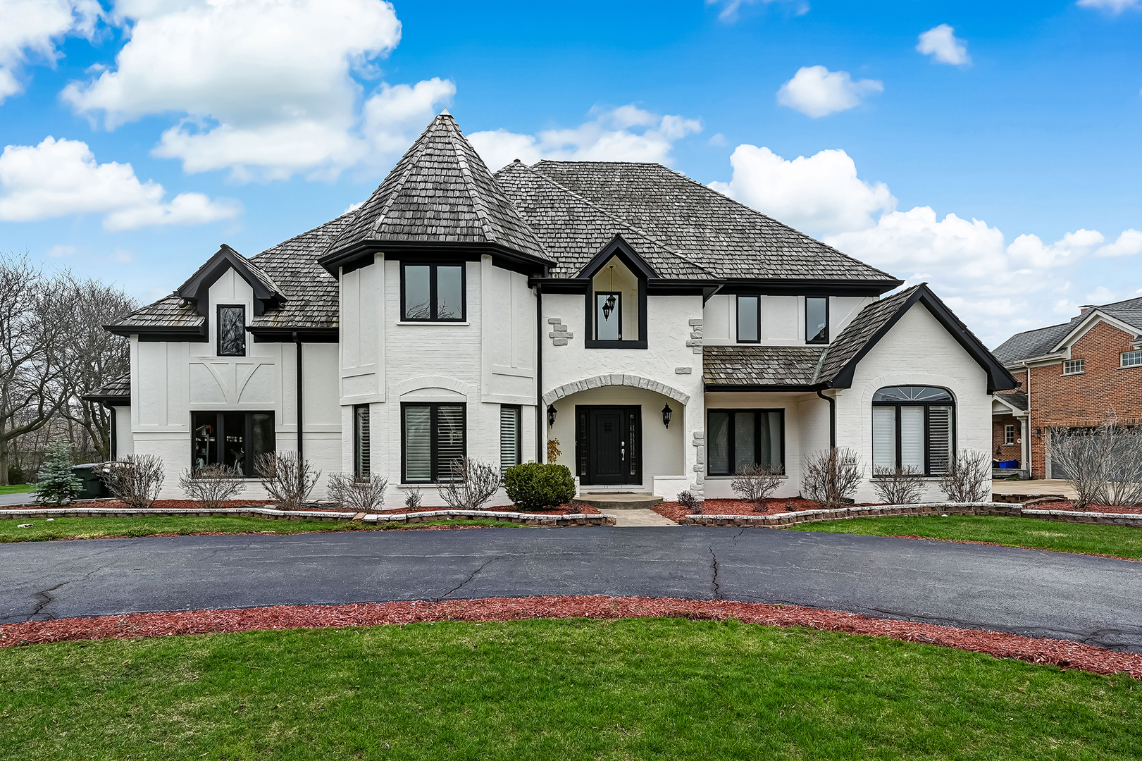 1449 Tomlin Drive Burr Ridge, IL 60527 - Photo 1 of 46 a front view of a house with garden and trees