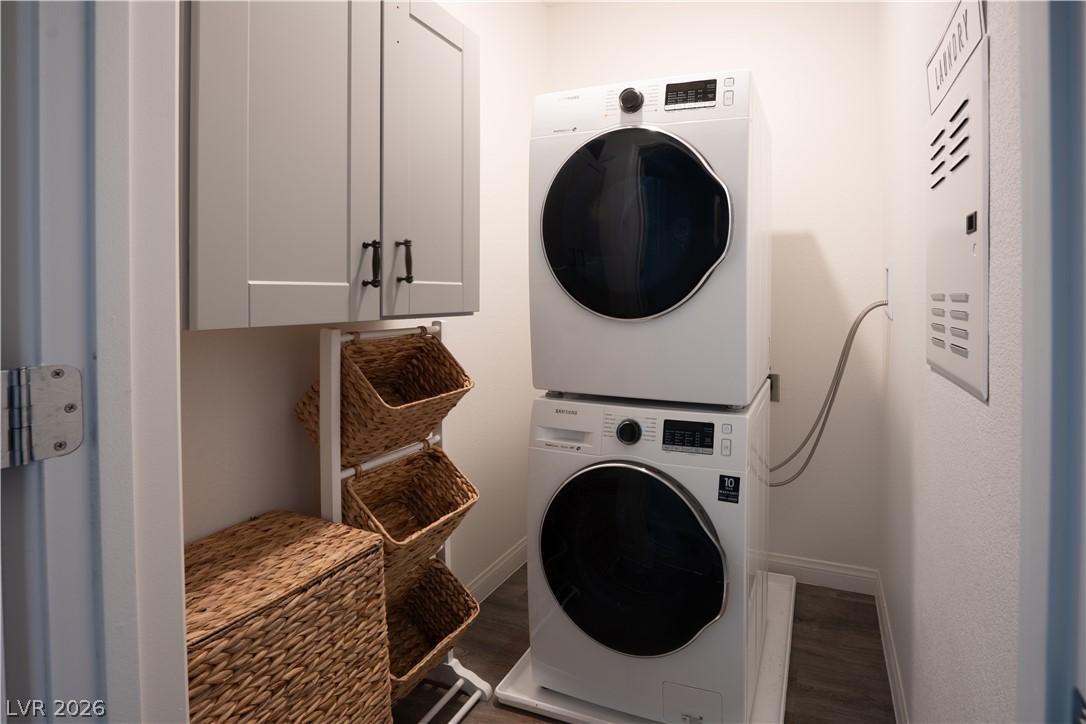 12267 Desert Light Road, Unit 4 Las Vegas, NV 89183 - Photo 12 of 18 A dedicated laundry closet offers convenient stacked appliances and organized storage solutions.