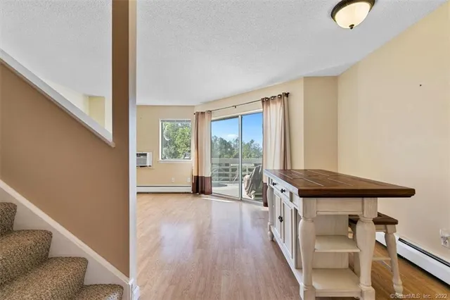 a view of a livingroom with furniture wooden floor and windows