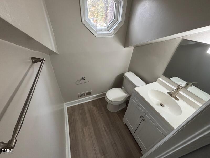 1277 Buffalo Road Smithfield, NC 27577 - Photo 14 of 14 a white toilet sitting next to a bathroom sink