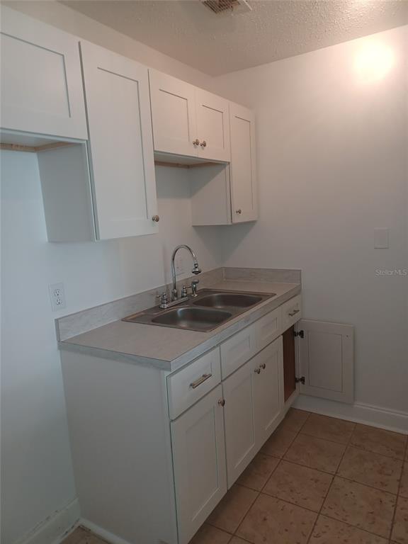 245 South McMullen Booth Road, Unit 17 Clearwater, FL 33759 - Photo 2 of 4 a kitchen with a sink cabinets and utility