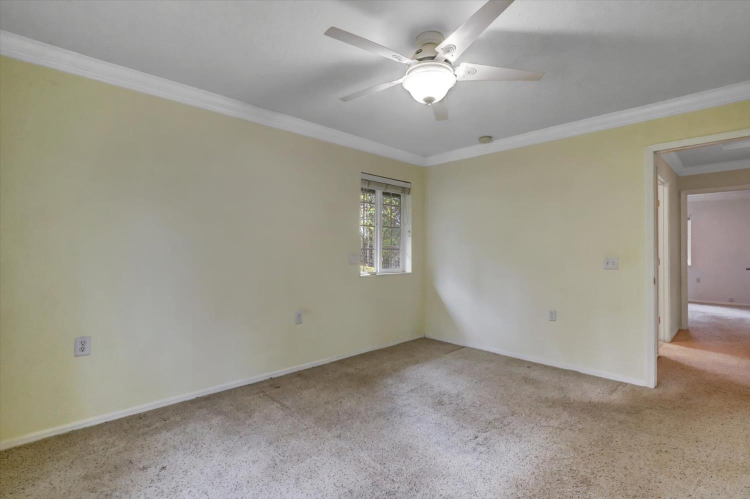 19121 Hiers Road Grass Valley, CA 95949 - Photo 27 of 94 an empty room with a ceiling fan and a window