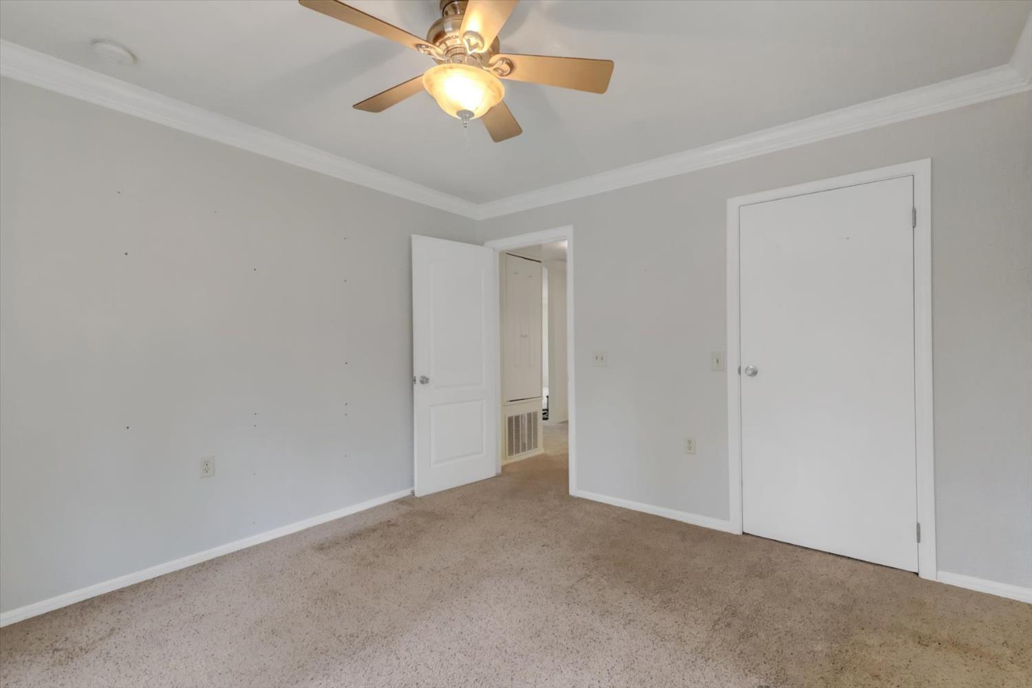 19121 Hiers Road Grass Valley, CA 95949 - Photo 31 of 94 an empty room with a chandelier fan and closet area