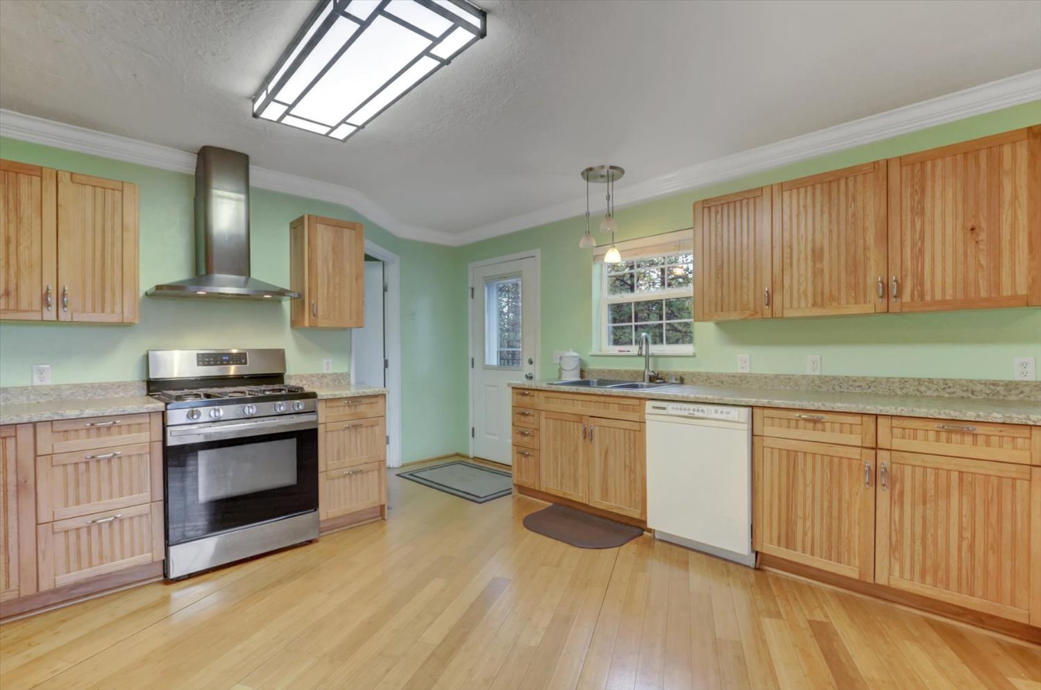 19121 Hiers Road Grass Valley, CA 95949 - Photo 6 of 94 a kitchen with stainless steel appliances granite countertop a stove a sink and a microwave
